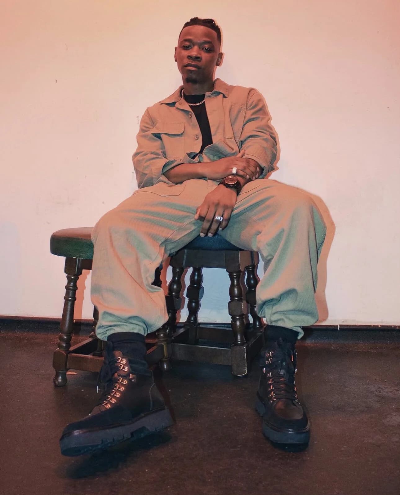 A performer connected to Breaking Barz, seated portrait