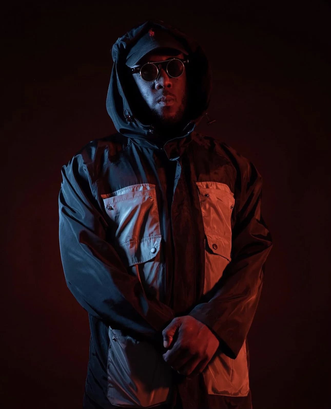 A performer connected to Breaking Barz, portrait under red light
