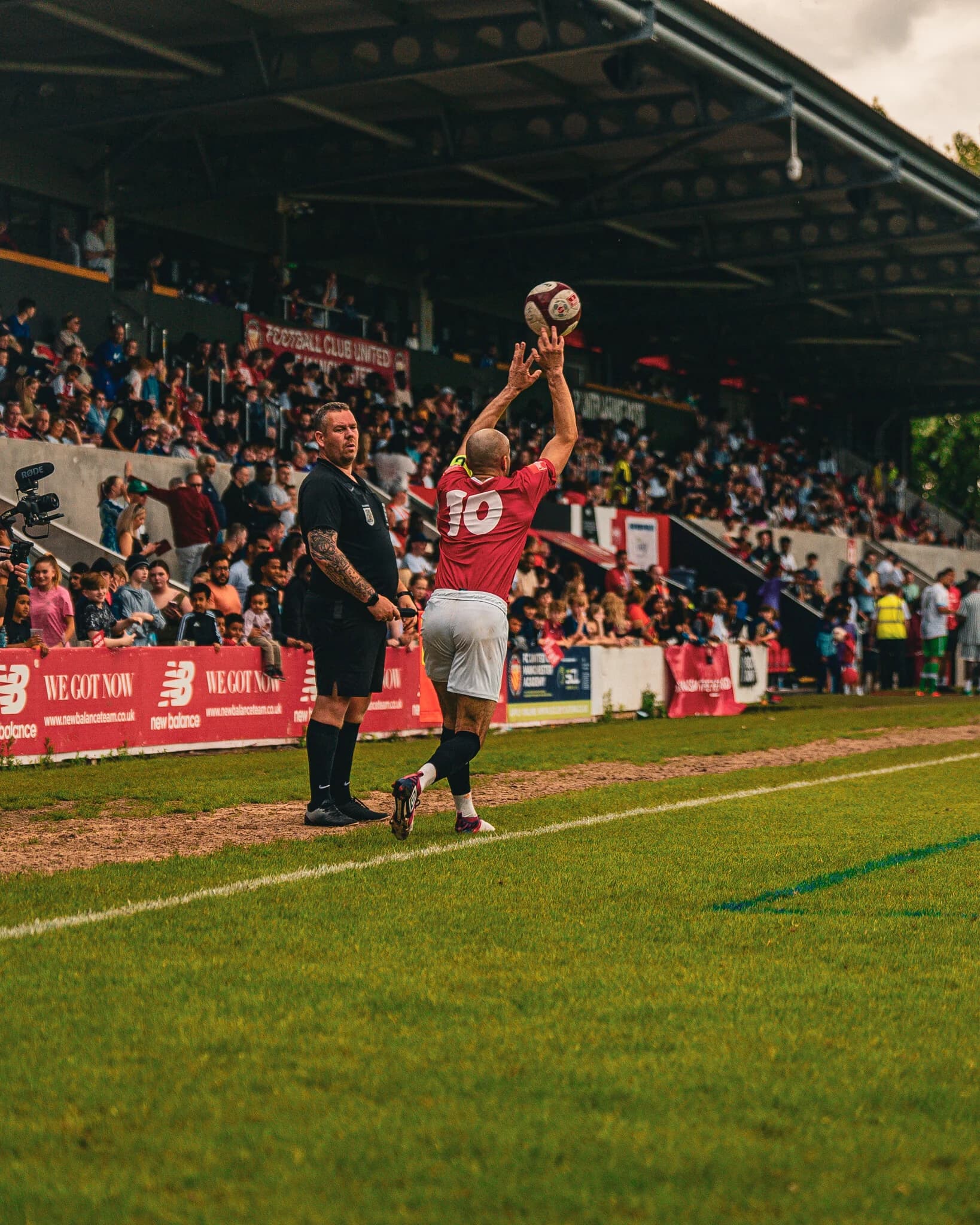 A player takes a throw-in during the charity match